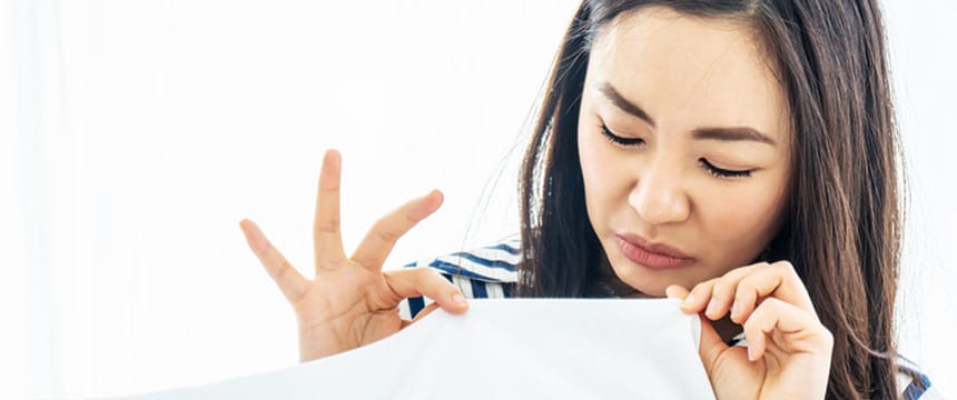 Woman smelling a musty smell in house